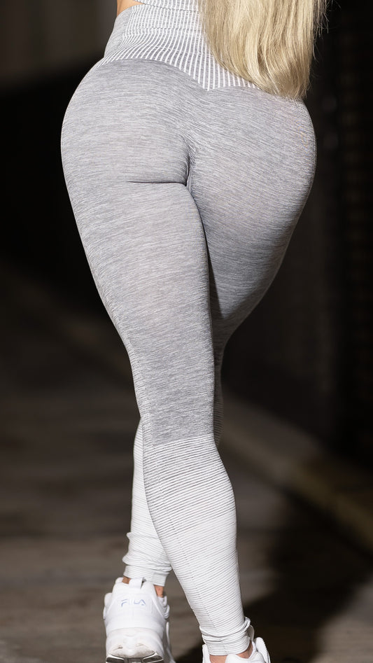 Image of a woman wearing the grey and white Pump Leggings from MiniBeast. 