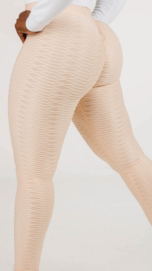 Image of a woman wearing the 3D Leggings in beige from MiniBeast. 